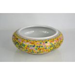 A Chinese porcelain brush wash bowl, painted in Imperial yellow ground with floral decoration,