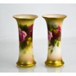 A pair of Royal Worcester trumpet vases, painted with roses, 5ins high.