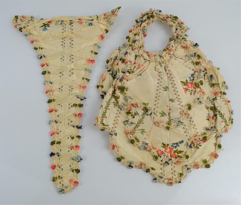 Two 19th century embroidery samples on silk, one of corset form embroidered with flowers and