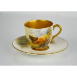 A Royal Worcester cup and saucer by H. Stinton, painted with highland cattle in landscape, gilded