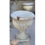 A pair of large stone garden urns.