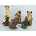 A group of cast iron door stops to include Judy, What Every Woman Wants and three in the form of