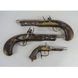 A vintage flintlock pistol lighter together with a pair of 19th century replica pistols