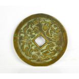 A Chinese bronze disc, with calligraphy to one side and erotica scenes the other.