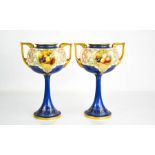 A pair of Royal Worcester pedestal vases of Art Deco design, by Horace Price, painted with