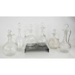 Six Edwardian glass oil jars and stoppers.