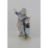 A Lladro clown, standing beside a magic hat with kittens, 5892, 28cm high.