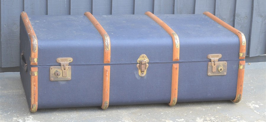A vintage travelling trunk with wooden banding.