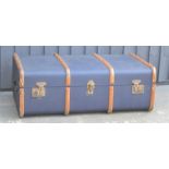 A vintage travelling trunk with wooden banding.