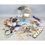 A large quantity of jewellery to include brooches, earrings, pocket watch, necklaces, some silver