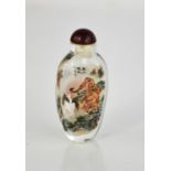 A Chinese reverse painted glass snuff bottle depicting tiger, with jade stopper.