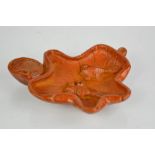 A Chinese natural heitian jade hand carved ink stand in the form of a leaf and carp.