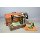 A vintage Singer sewing machine No99 with original instructions together with a Grain child's sewing