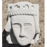 A hand-carved Portland stone corbel depicting a bishops head in the medieval style, carved by