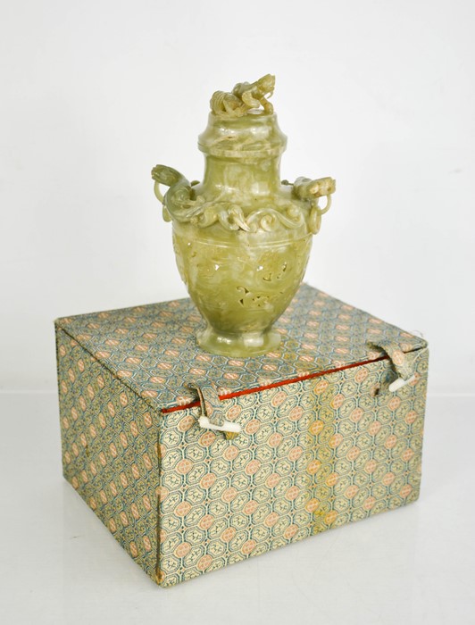 A Qing Dynasty Hetian green jade censer with hanging ring handles and cover.