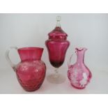 Three pieces of Victorian Cranberry glass to include sweet jar and one painted with girl blowing