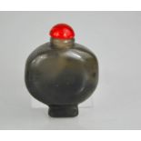 A Chinese vintage natural smoky grey jade carved snuff bottle with red jade stopper.