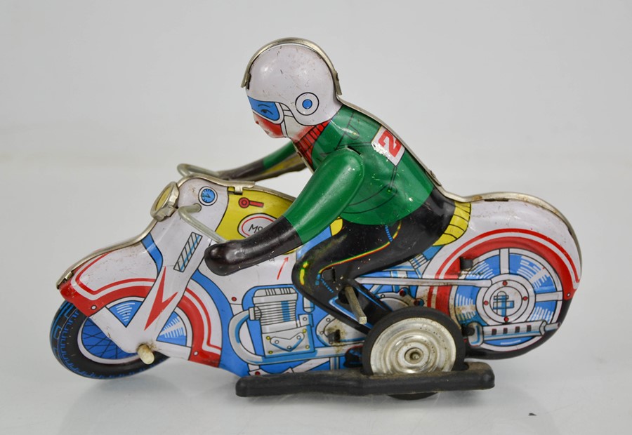 A vintage tin wind- up motorbike.