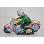 A vintage tin wind- up motorbike.