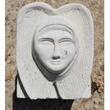 A hand-carved Portland stone corbel of angel head wings carved by local artist Timothy Ennis