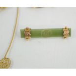A 9ct gold and jade brooch carved with a flower to centre together with a yellow metal and