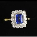 An 18ct yellow and white gold, sapphire (1.10ct) and diamond (0.48ct) ring, size O, 4.1g.