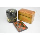 A black painted box painted with daisies, a leather card case and counter.