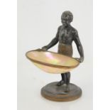 A 19th Century Spelter Blackamoor figure holding a basket formed from mother of pearl with