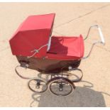 A child's Silver Cross pram and bedding.