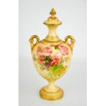 A Royal Worcester blush ivory vase and cover, painted with flowers, with twin handles and cover with