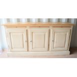 A pine hall sideboard with three cupboards and pull out shelves, 165cm wide by 42cm depth by 81cm