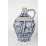 A stoneware blue and grey bellarmine jug, embossed with stylised flowers. A/F