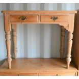 A pine two drawer hall table, 75cm high by 91cm wide by 48cm
