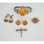 A silver and amber bracelet together with two pairs of silver and amber earrings, silver and amber