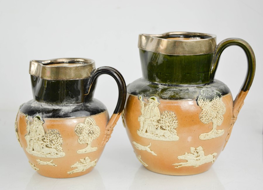 Two Victorian stoneware jugs with silver rims.