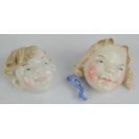 Two Metzler and Ortloff porcelain wall hanging face masks of boy and girl