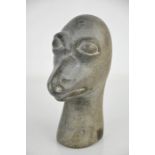 A hand carved stone doorstop in the form of a dodo head.