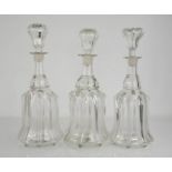 Three moulded glass decanters with stoppers.