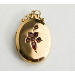 A 9ct gold antique oval ruby set locket, 4.75g.