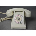 A vintage cream bakelite phone.