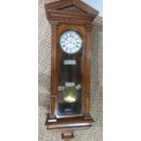 A 19th century Vienna wall clock with Roman numeral dial and glass door enclosing pendulum, 123cm