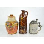 A Doulton bottle depicting George One Guard, a Doulton jar & cover and a German stein with pewter