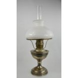 A steel paraffin lamp with white glass shade.