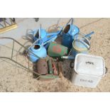 A vintage enamel bread bin together with a child's push along lawnmower and a group of watering cans