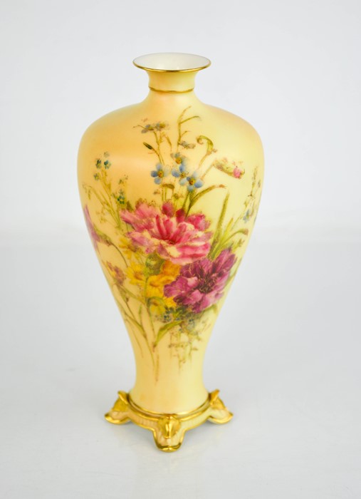 A Royal Worcester blush ivory slender vase, painted with flowers, raised on four gilded feet,