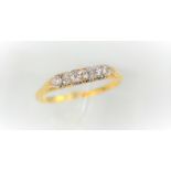 An 18ct gold ring with five diamonds in a claw setting, size S 1/2, 2.62g