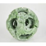 A Chinese green jade five section puzzle ball, and stand carved with a dragon, 10cm high.