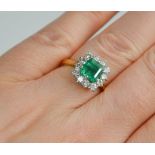 An 18ct gold square cut emerald and diamond ring, approximately 1.5ct emerald, bordered by