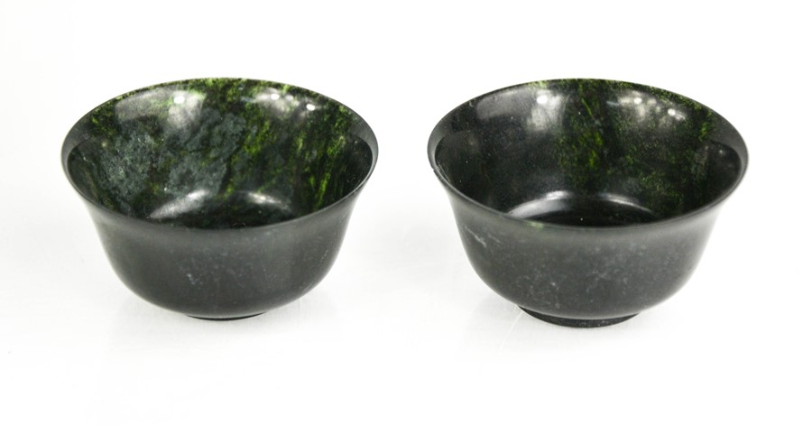 A pair of Chinese Heitian spinach jade tea bowls.