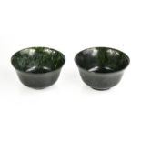 A pair of Chinese Heitian spinach jade tea bowls.